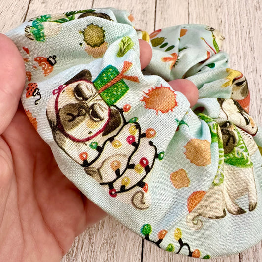 Medium sized light blue scrunchie with Christmas pugs