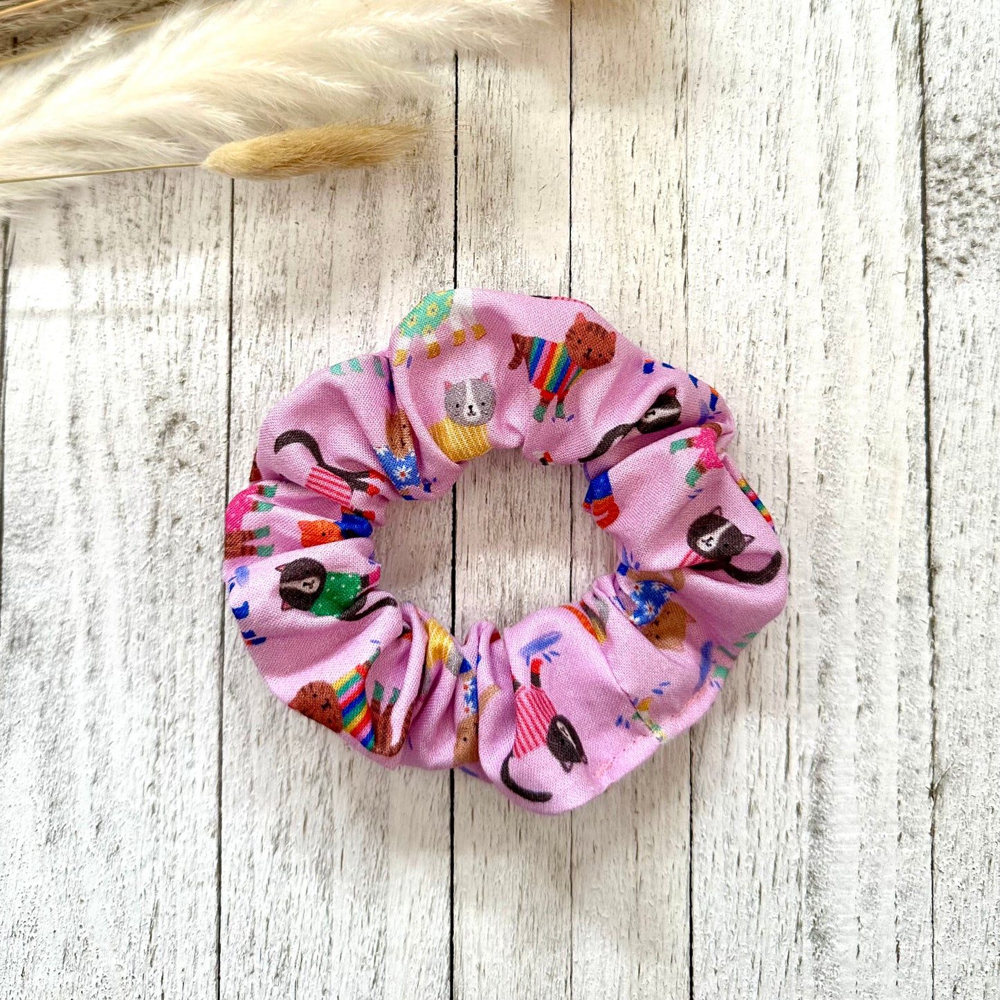 Light pink scrunchie with cats in sweatshirts