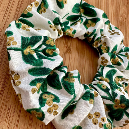 White scrunchie with green and gold leaves